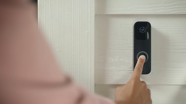 Person pressing on a Blink Video Doorbell