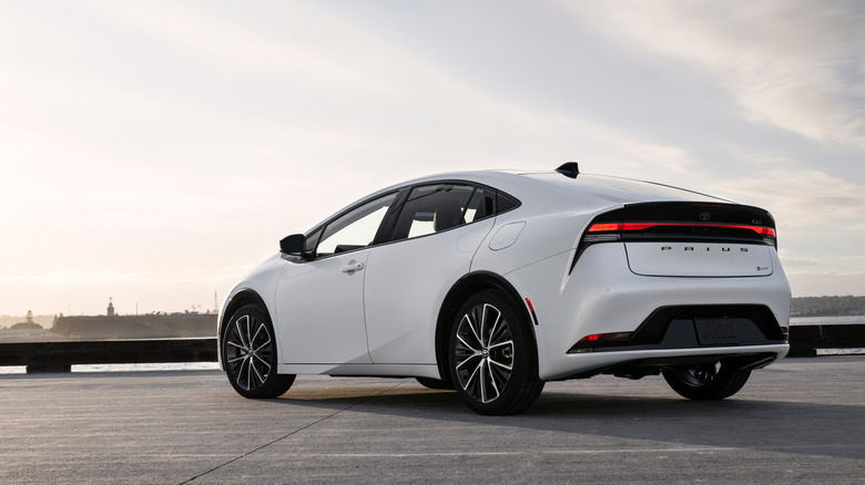 Rear three-quarter view of white 2026 Toyota Prius in a parking lot.