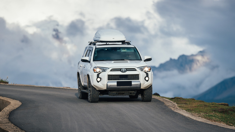 A white Toyota driving in high altitudes