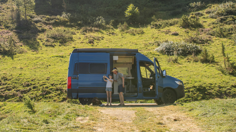 People in a camper in the wilderness