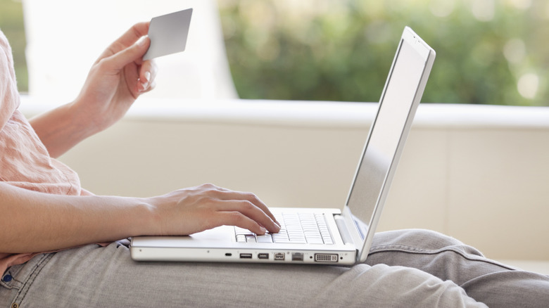 Person shopping for something online, looking at their credit card