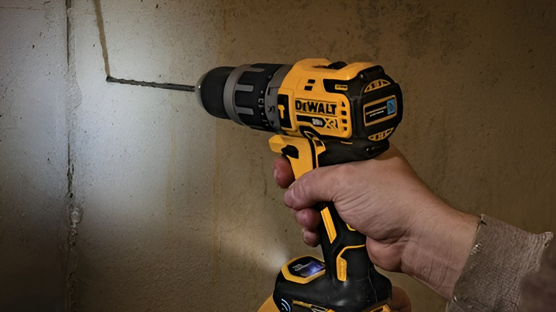 Person drilling in wall with DeWalt Tool Connect hammer drill