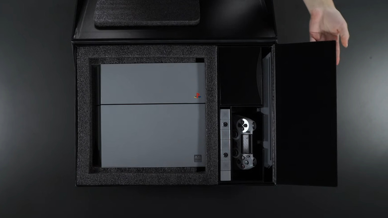 A rare 20th anniversary edition gray PlayStation 4 being unboxed showing the console and controller.