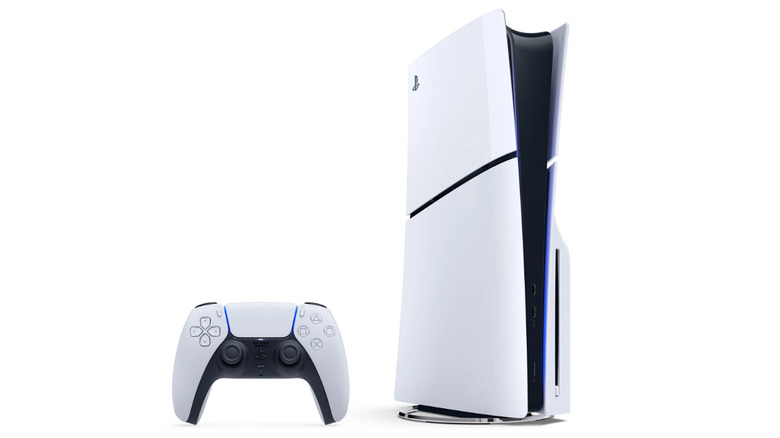 A white, upright PlayStation with a DualSense controller next to it on a plain white background.