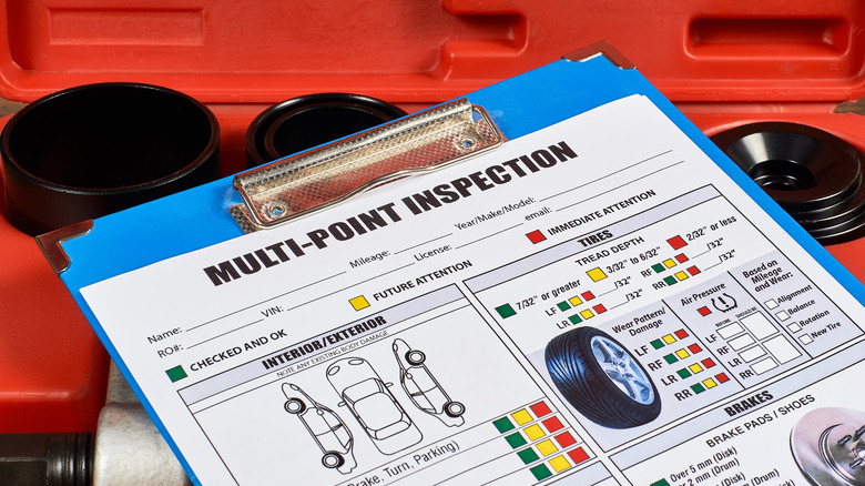 Vehicle multi-point inspection sheet on a clipboard