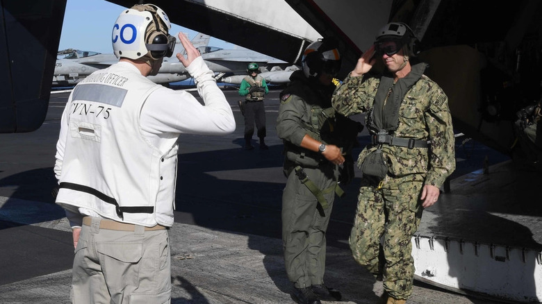 White shirt greeting an arriving Admiral