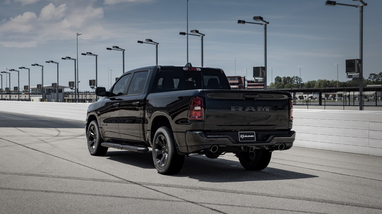 Rear 3/4 view of a black 2026 Ram 1500 at a drag strip