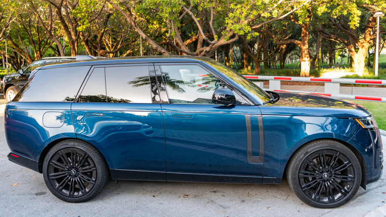 a blue land rover range rover sport at a parking lot