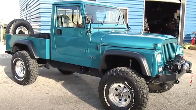 Blue Jeep CJ-10 truck parked