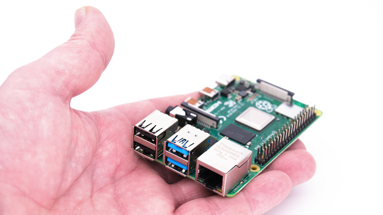 Person holding a Raspberry Pi 4 module.