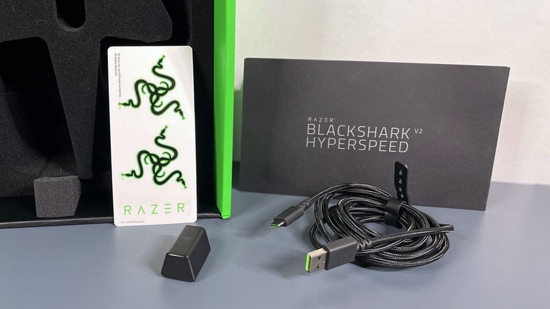 stickers, Wireless Dongle, USB cable, and instructions that are included with the BlackShark V2 HyperSpeed headphones