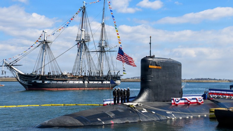 The USS Constitution sails past USS Massachusetts (SSN-798) during its commissioning ceremony