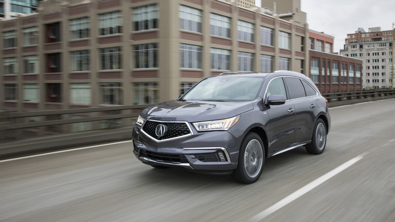 2020 Acura MDX traveling at speed on an urban highway