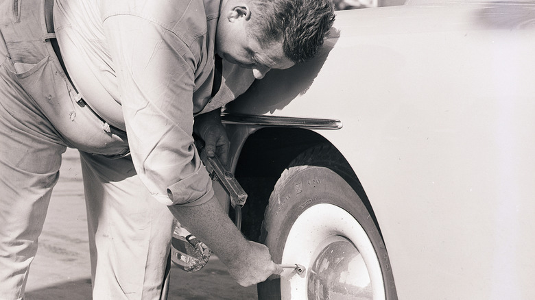 person inflating car tires