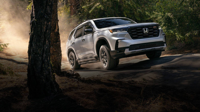 2025 Honda Pilot driving through the woods