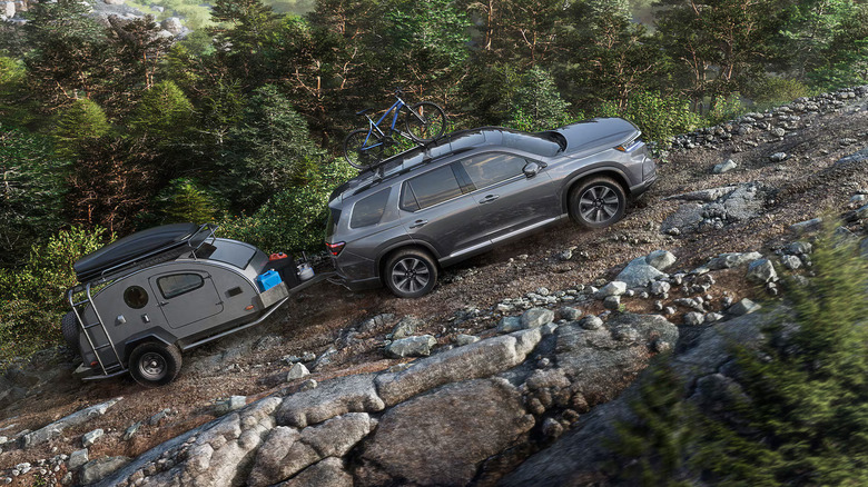 2025 Honda Pilot towing a camper up a mountain