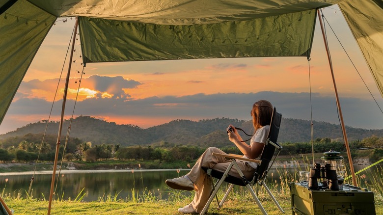 Person in tent looking at sunset