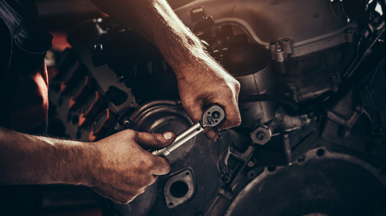 Close-up of a mechanic working on a diesel engine