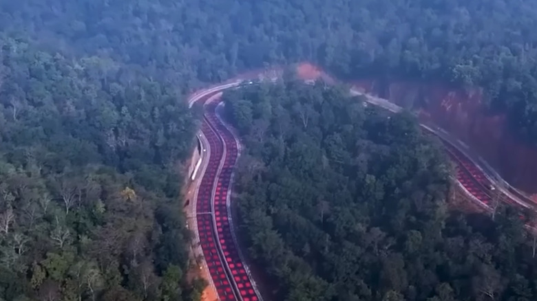 Ariel view of red squares painted on road in India with surrounding forrest