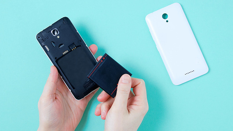 Removable battery smartphone in woman's hand