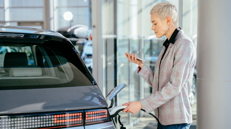 woman charging electric car