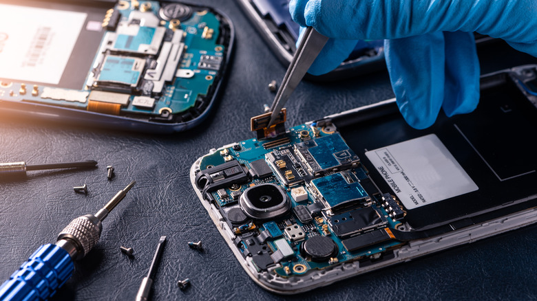 Two smartphones undergoing repairs