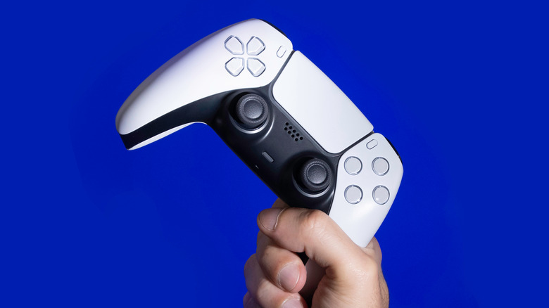 DualSense controller in hand