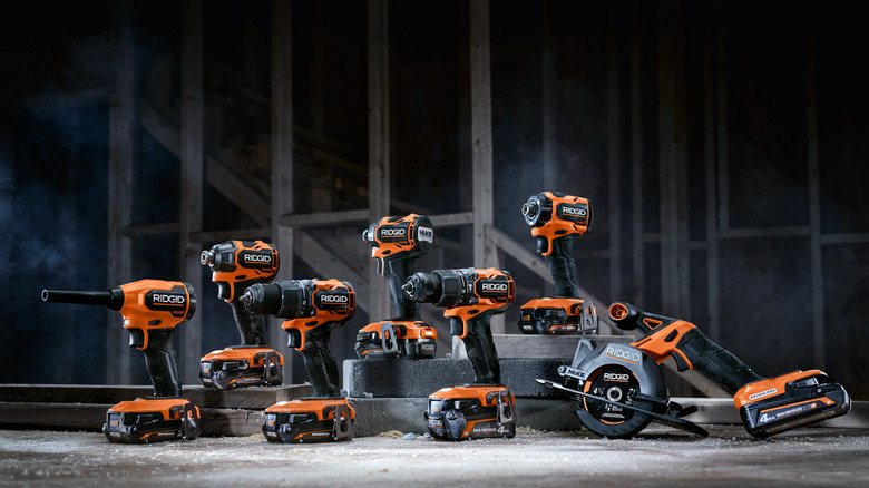 Seven Ridgid Nuke tools posed on the ground in a dark room.