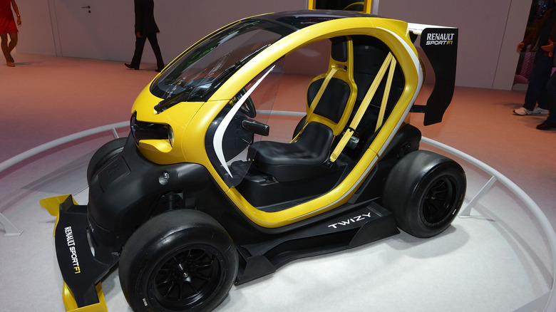 The Renault Twizy F1 at an auto show floor, front 3/4 view