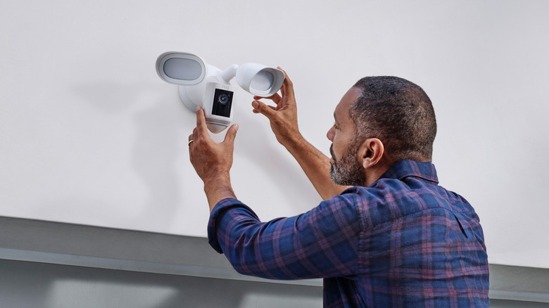 Man installing Blink Floodlight Cam