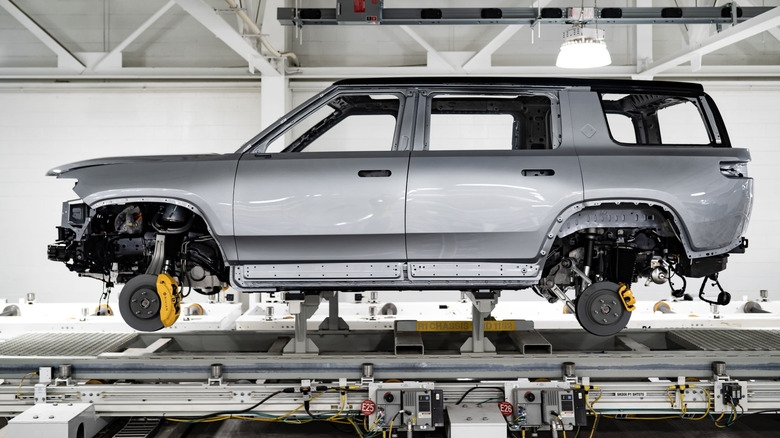 Side view of Rivian SUV body on assembly line