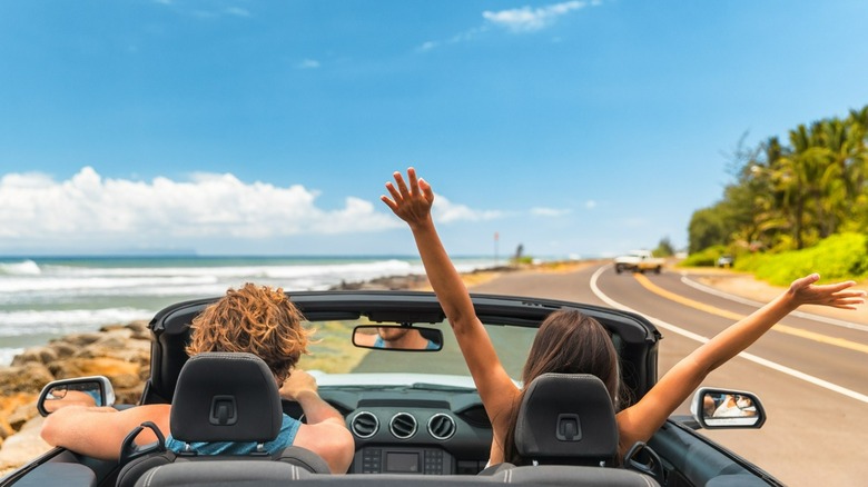 couple driving convertible 