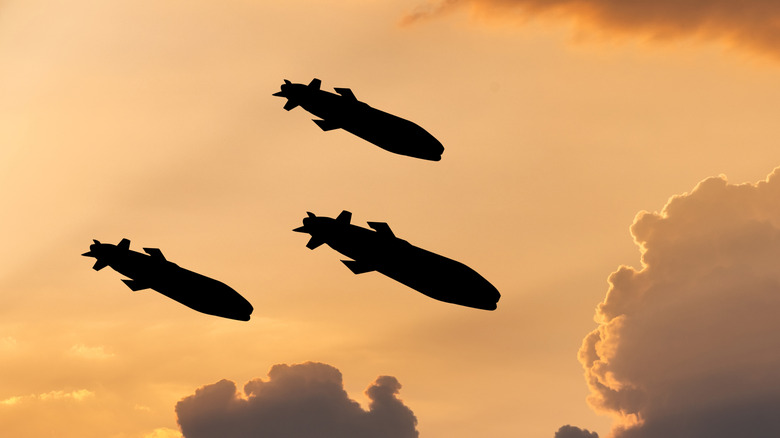 Silhouettes of three missiles flying through the air