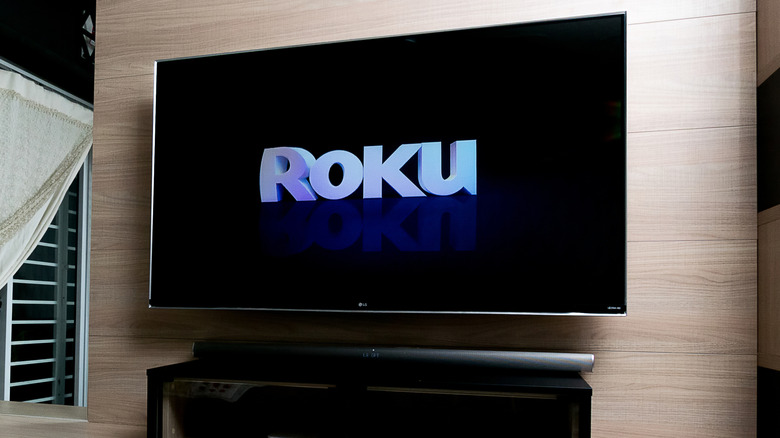 LG TV in living room showing Roku logo
