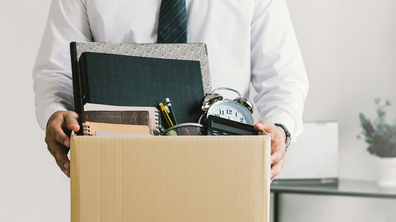 laid off man holding box