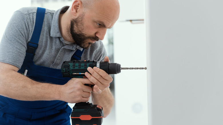 Worker using hammer drill