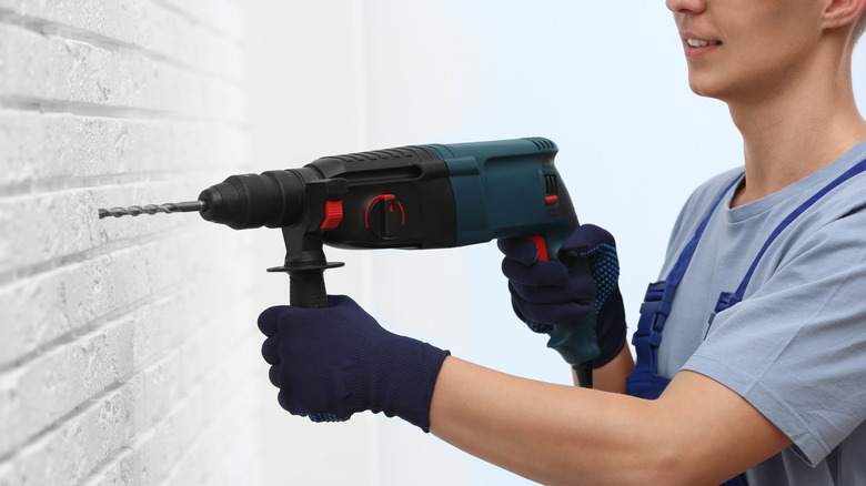 Worker using rotary hammer