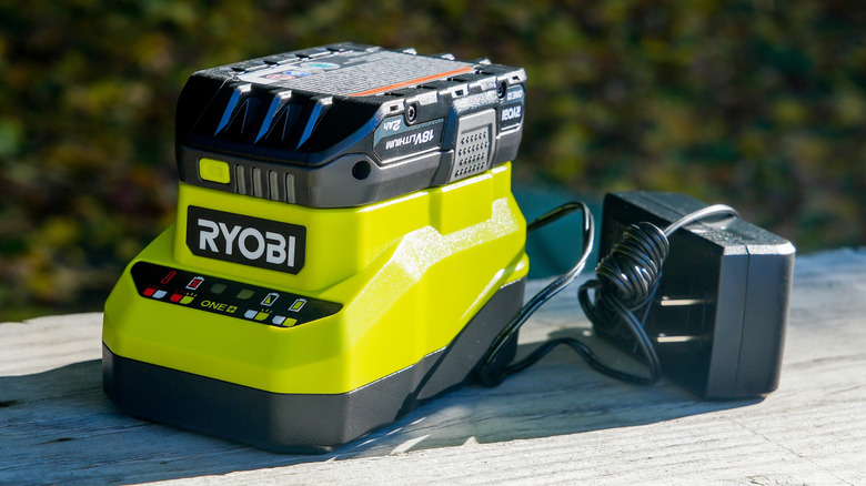 Unplugged Ryobi battery charger with battery sitting outside