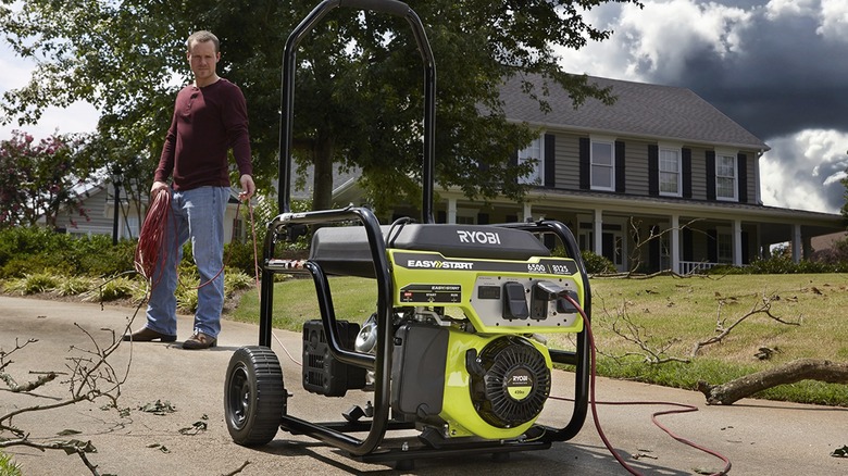 man looking at Ryobi generator