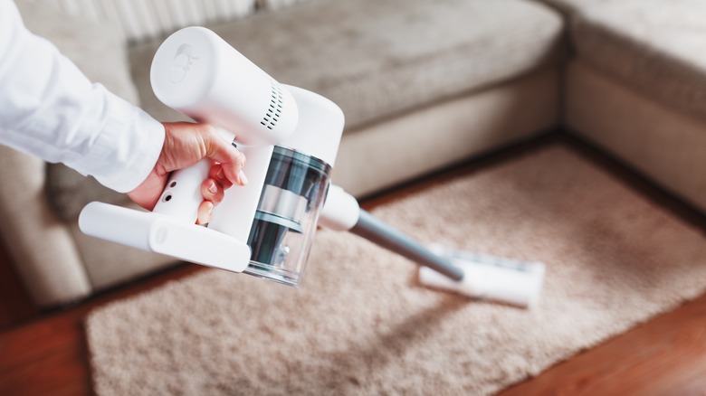 hand holding white vacuum