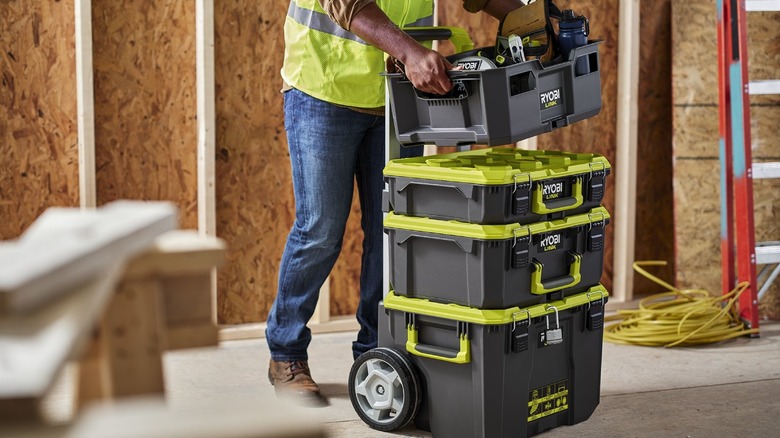 person lifting up modular tool storage system