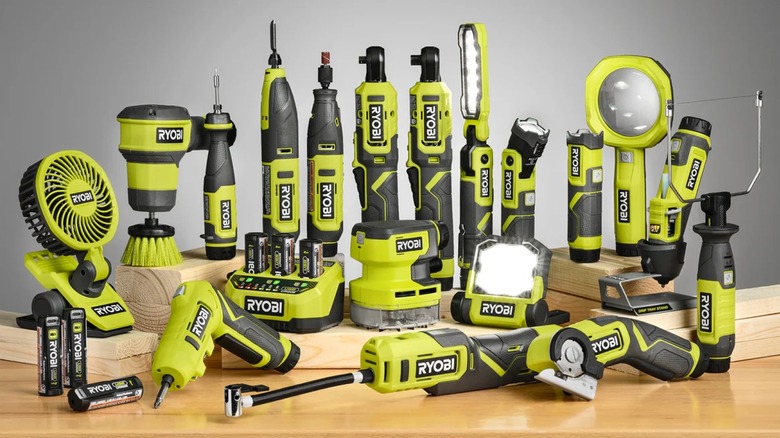 Several Ryobi tools on a table with lumber