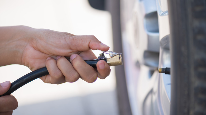 Person using tire inflator