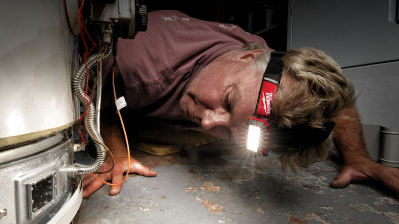 Man wearing a Milwaukee 2115-21 headlamp