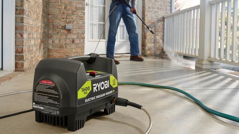 Person using Ryobi pressure washer