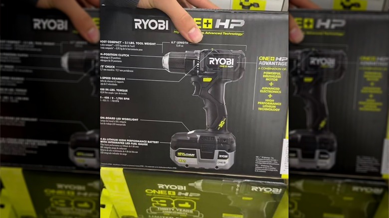 Person showcasing the back of the black Ryobi drill