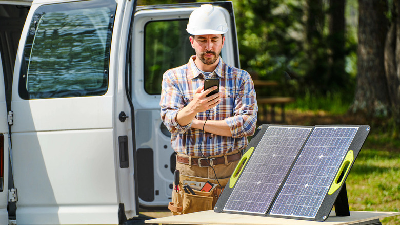 Solar Panel charging person's phone