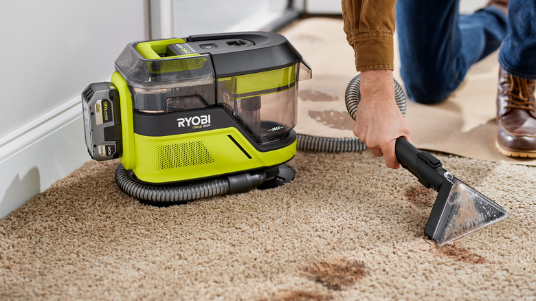 Ryobi vacuum cleaning a carpet stain