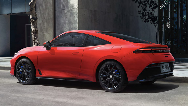 Left side view of red Honda Prelude parked on city street