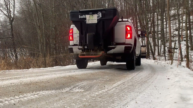 A Pickup Using A Tailgate Salt And Sand Spreader